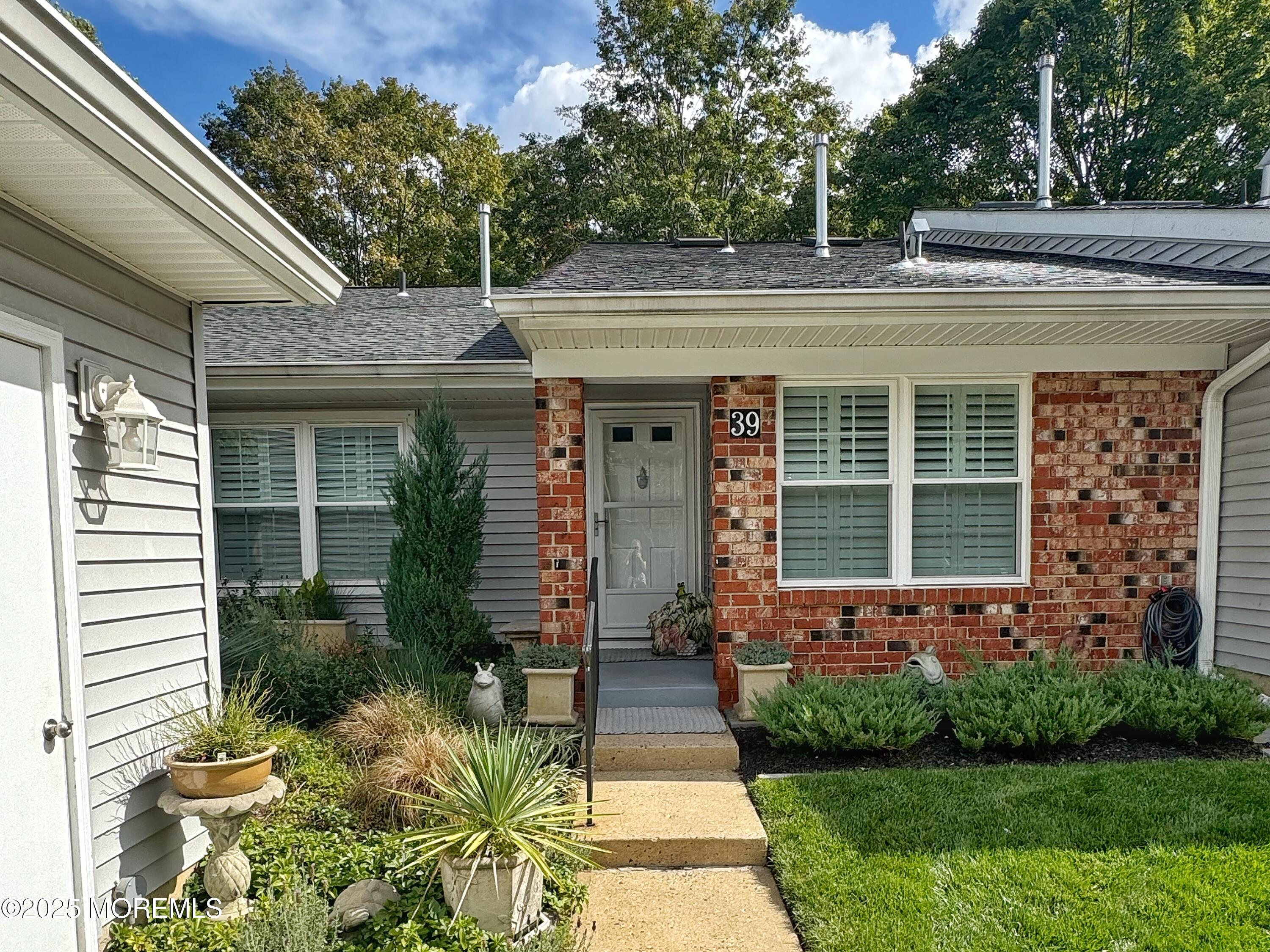 39 Boxwood Terrace Red Bank, NJ 07701 - Photo 2 of 25 a front view of a house with a garden