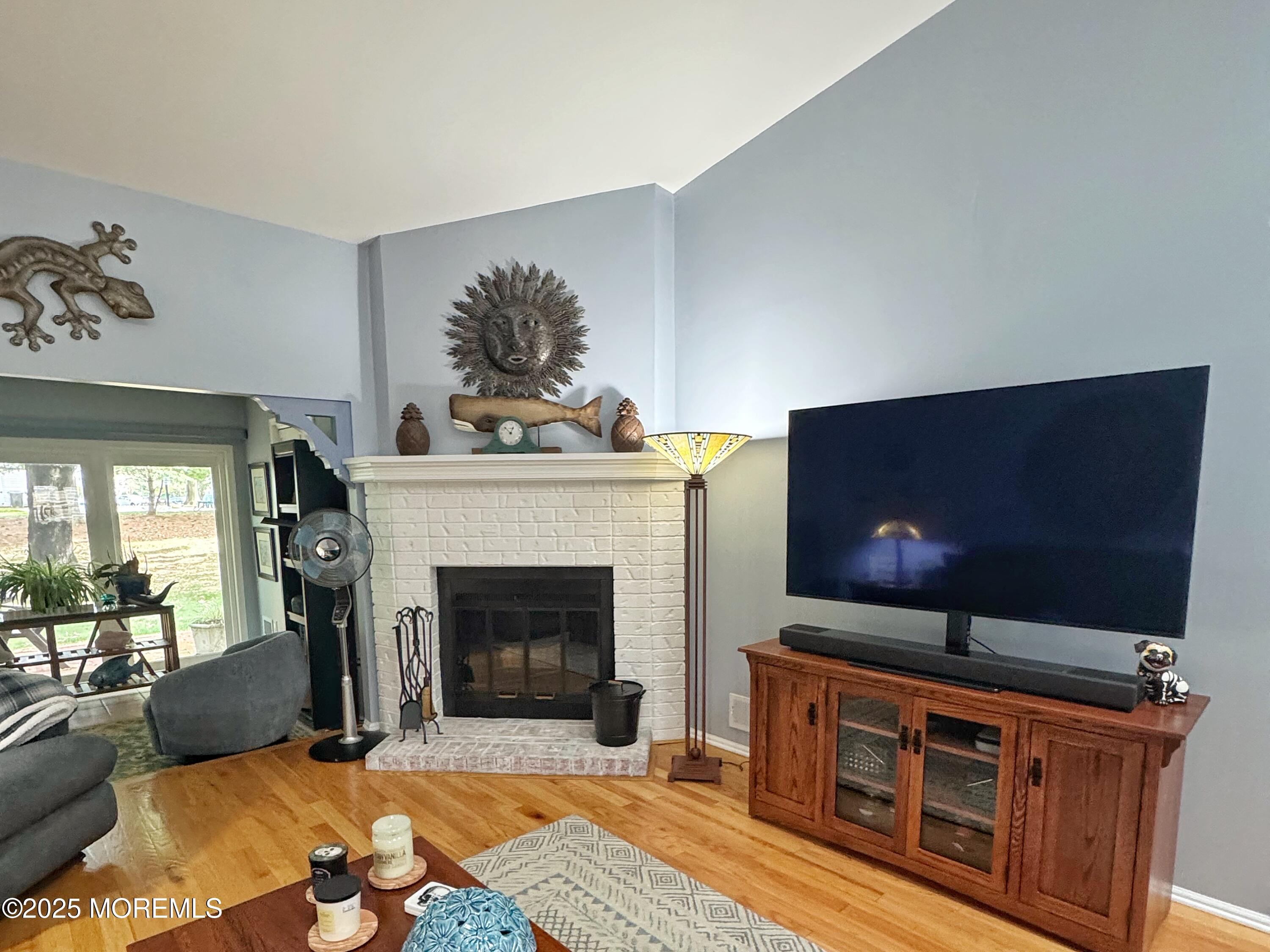 39 Boxwood Terrace Red Bank, NJ 07701 - Photo 5 of 25 a living room with furniture a flat screen tv and a fireplace