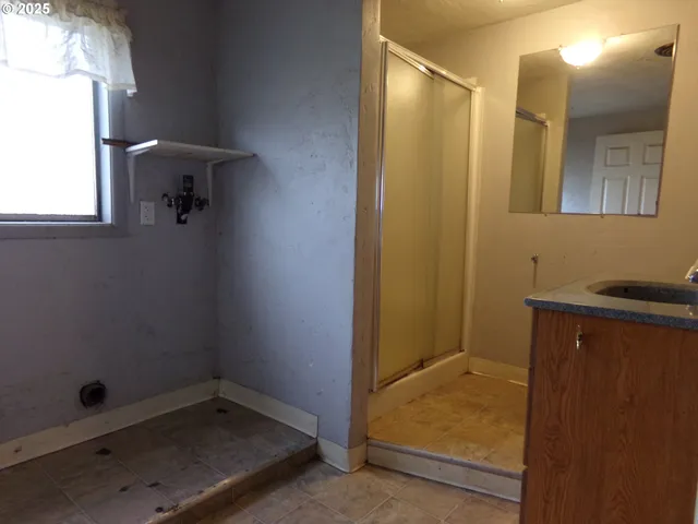 a bathroom with a shower and a sink