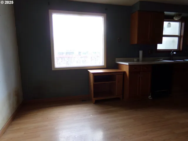 a kitchen with a window and cabinets