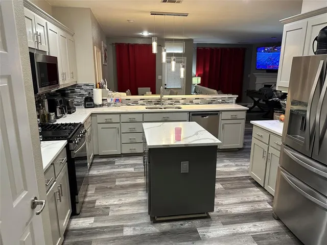 a kitchen with a sink stove and refrigerator
