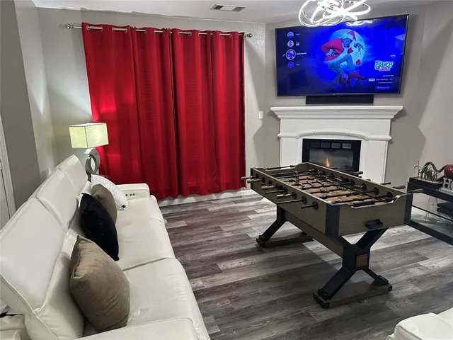 a living room with furniture a fireplace and a flat screen tv