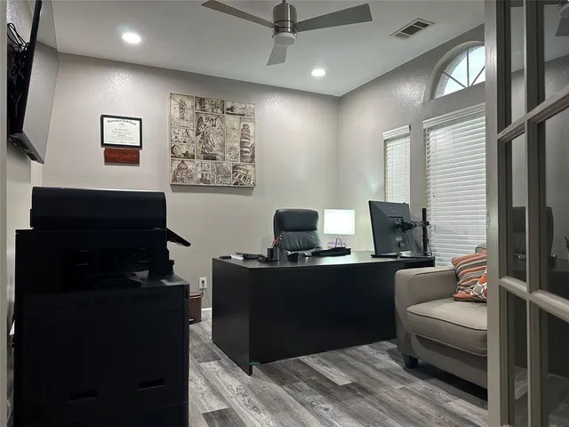 a living room with furniture a flat screen tv and a window