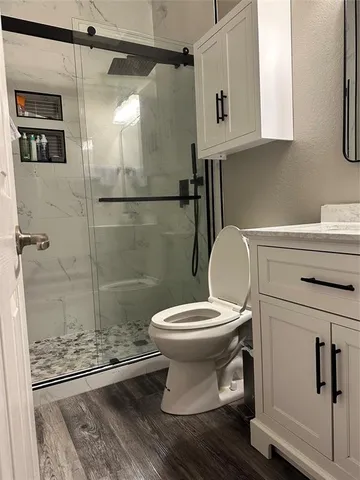 a bathroom with a toilet and a shower