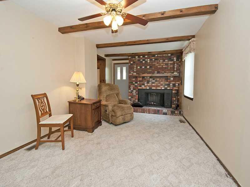 331 Rockfield Road Pittsburgh, PA 15243 - Photo 6 of 12 Family Room. attractive brick fireplace in neutrally decorated family room.