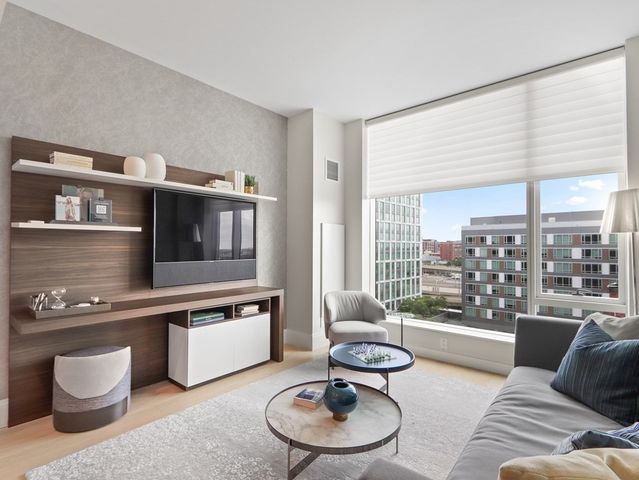 a living room with furniture and a floor to ceiling window