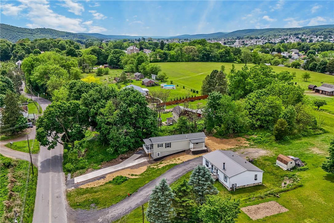 624 Main Road Lehighton, PA 18235 - Photo 5 of 42 Two distinct homes nestled on a green hillside with scenic distant views of the surrounding area.