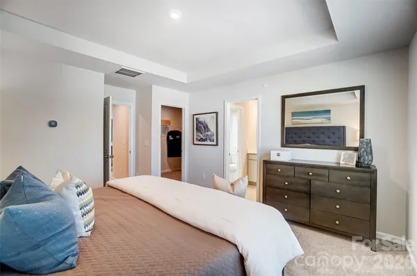 a bedroom with a bed and a dresser