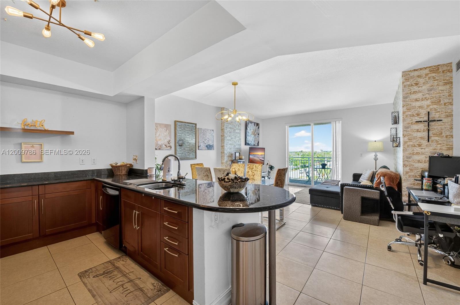 a kitchen with sink cabinets and living room