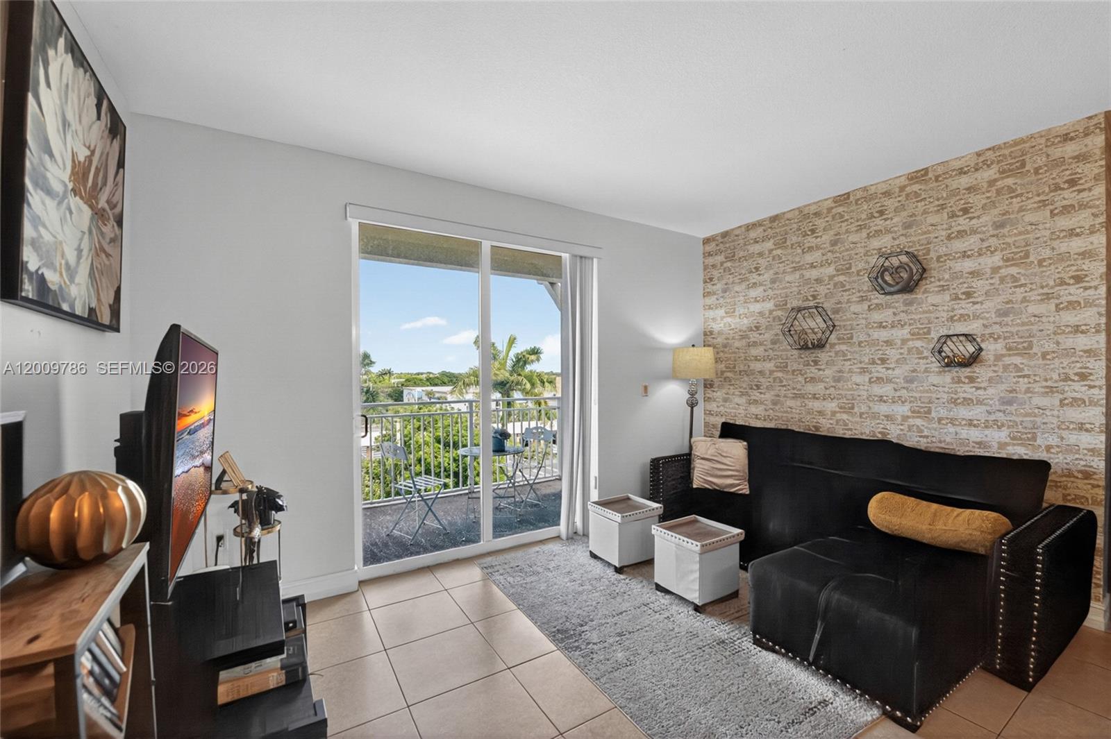 7266 Southwest 88th Street, Unit A403 Miami, FL 33156 - Photo 12 of 32 a living room with furniture and a fireplace