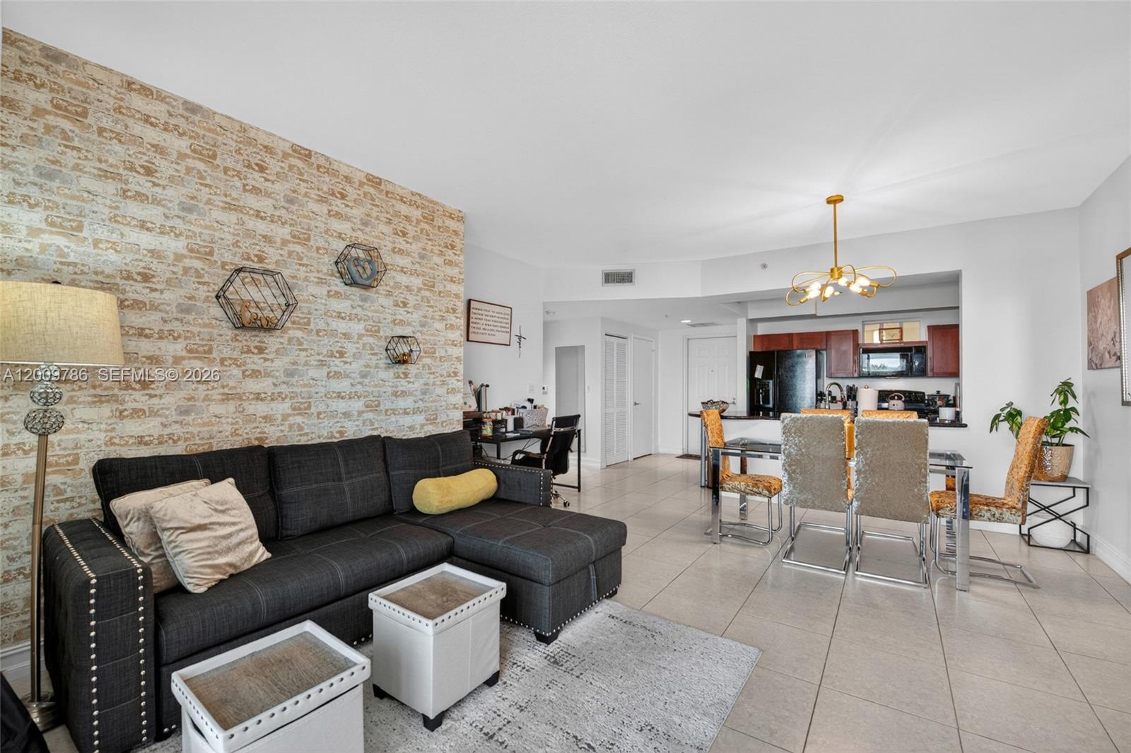 7266 Southwest 88th Street, Unit A403 Miami, FL 33156 - Photo 14 of 32 a living room with furniture and a chandelier