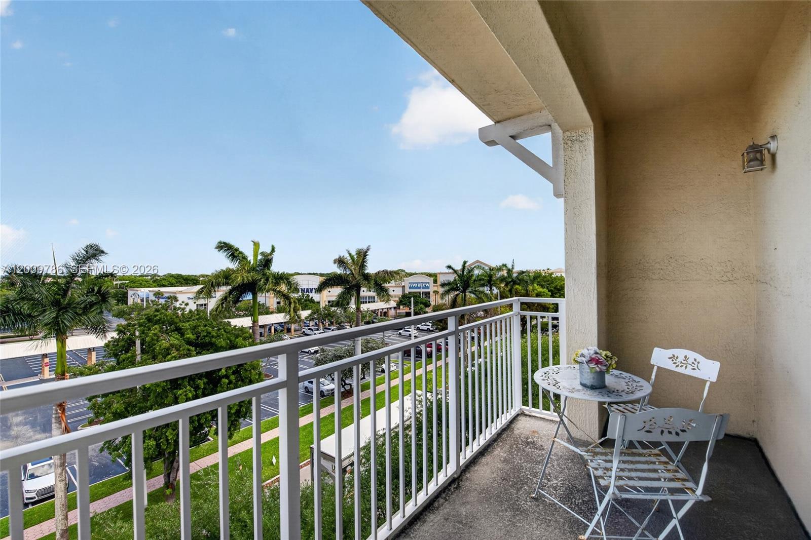 7266 Southwest 88th Street, Unit A403 Miami, FL 33156 - Photo 16 of 32 a view of a balcony with chairs