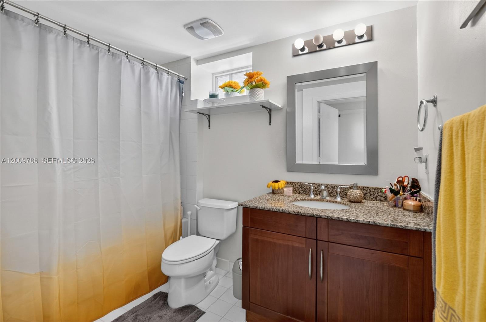 7266 Southwest 88th Street, Unit A403 Miami, FL 33156 - Photo 18 of 32 a bathroom with a toilet a sink and a mirror