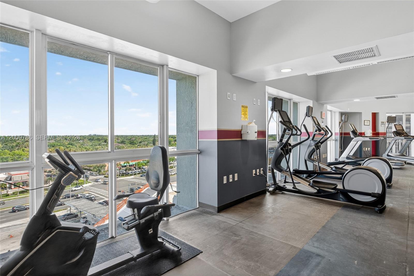7266 Southwest 88th Street, Unit A403 Miami, FL 33156 - Photo 26 of 32 a view of a room with gym equipment