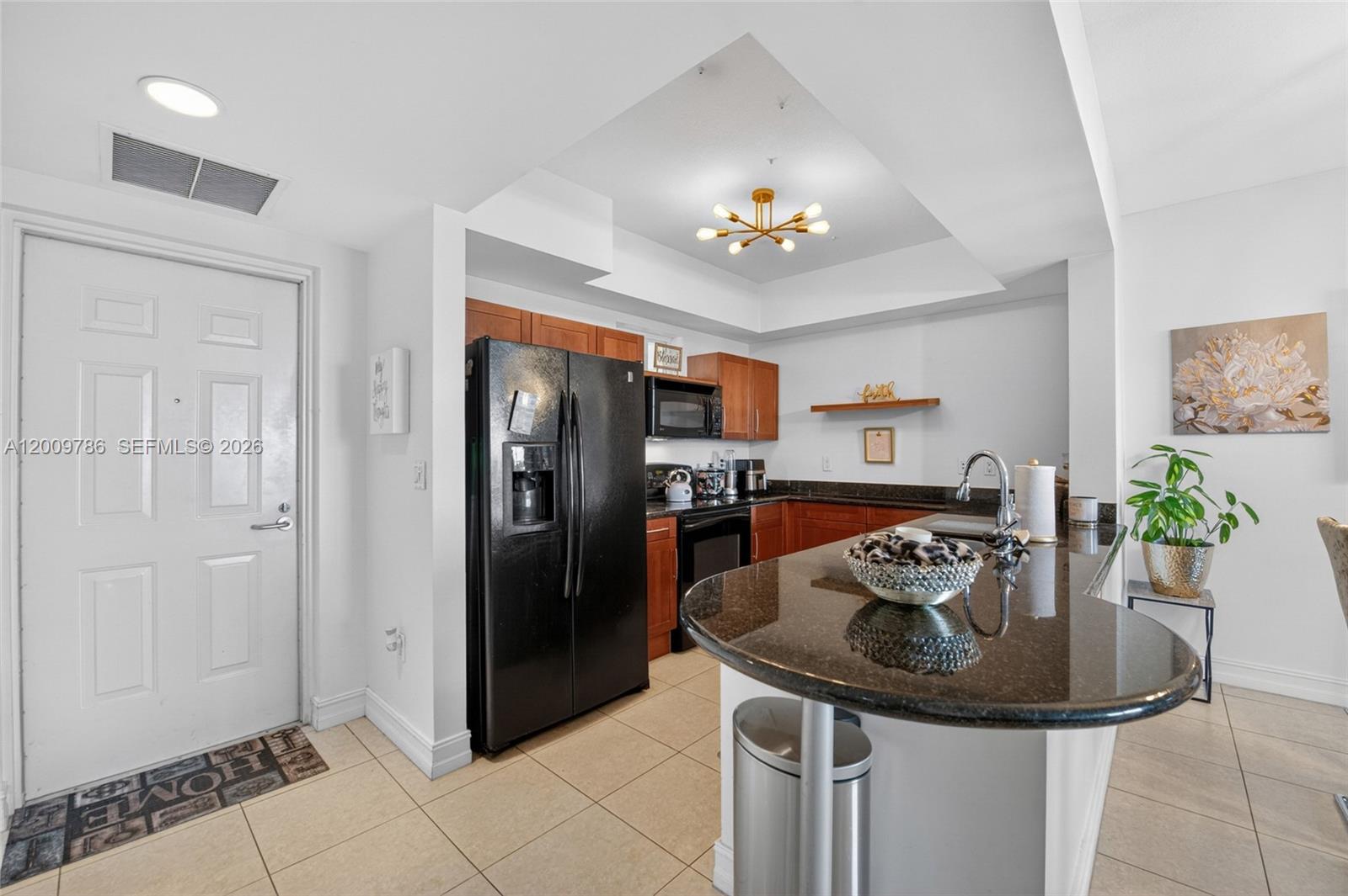 7266 Southwest 88th Street, Unit A403 Miami, FL 33156 - Photo 5 of 32 a kitchen with a sink refrigerator and microwave