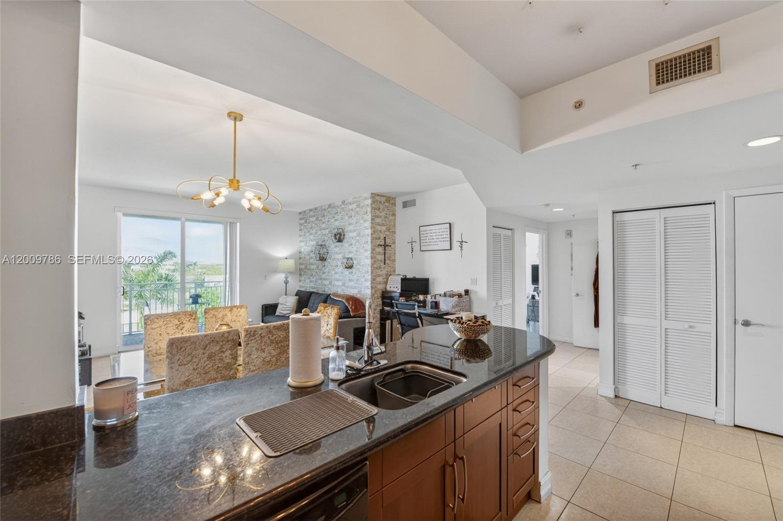 7266 Southwest 88th Street, Unit A403 Miami, FL 33156 - Photo 7 of 32 a kitchen that has a lot of cabinets in it