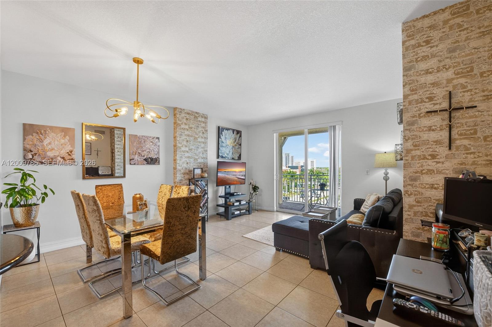 7266 Southwest 88th Street, Unit A403 Miami, FL 33156 - Photo 9 of 32 a living room with furniture a dining table and a fireplace