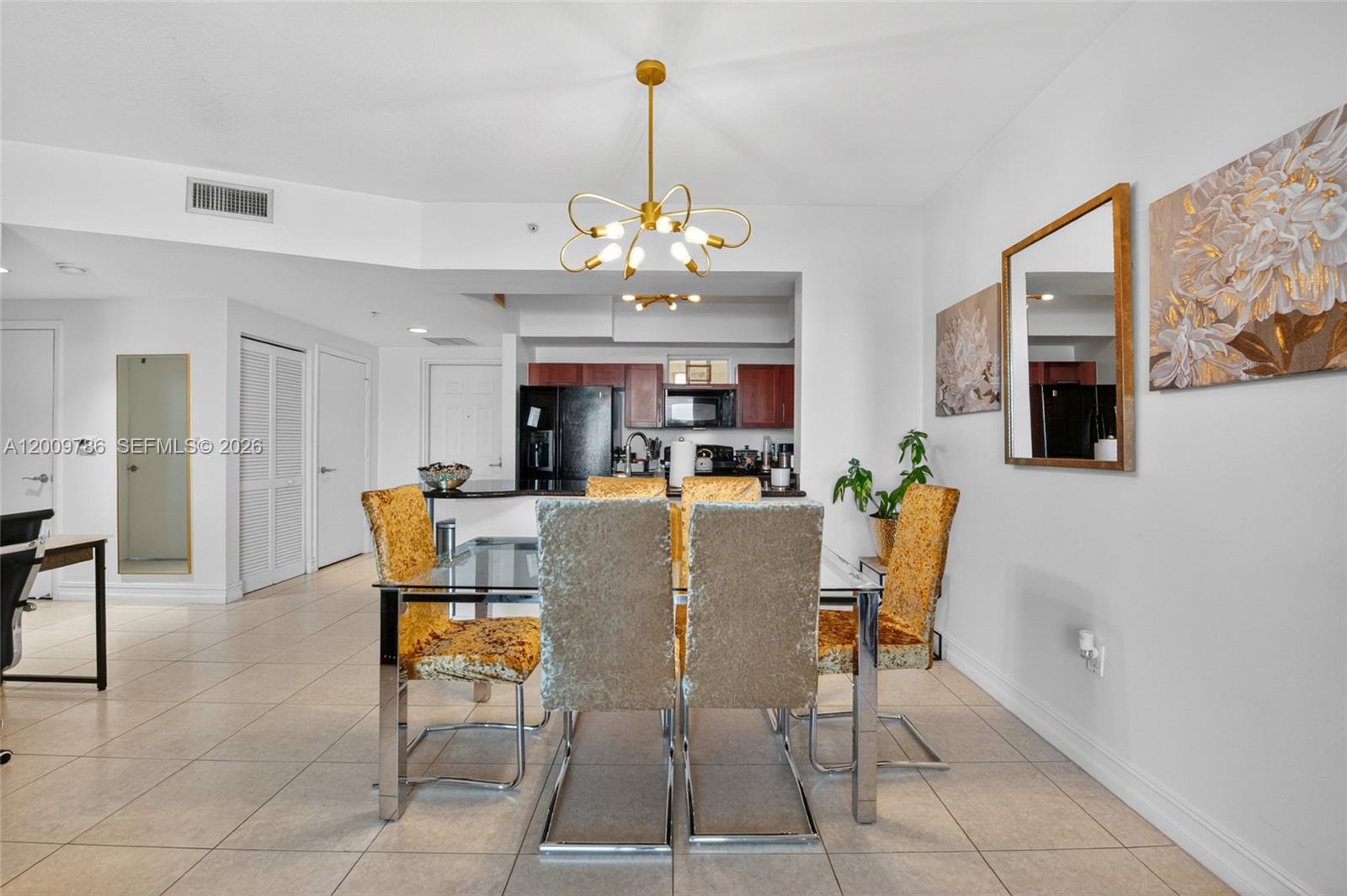 7266 Southwest 88th Street, Unit A403 Miami, FL 33156 - Photo 10 of 32 a view of a dining room with furniture and chandelier