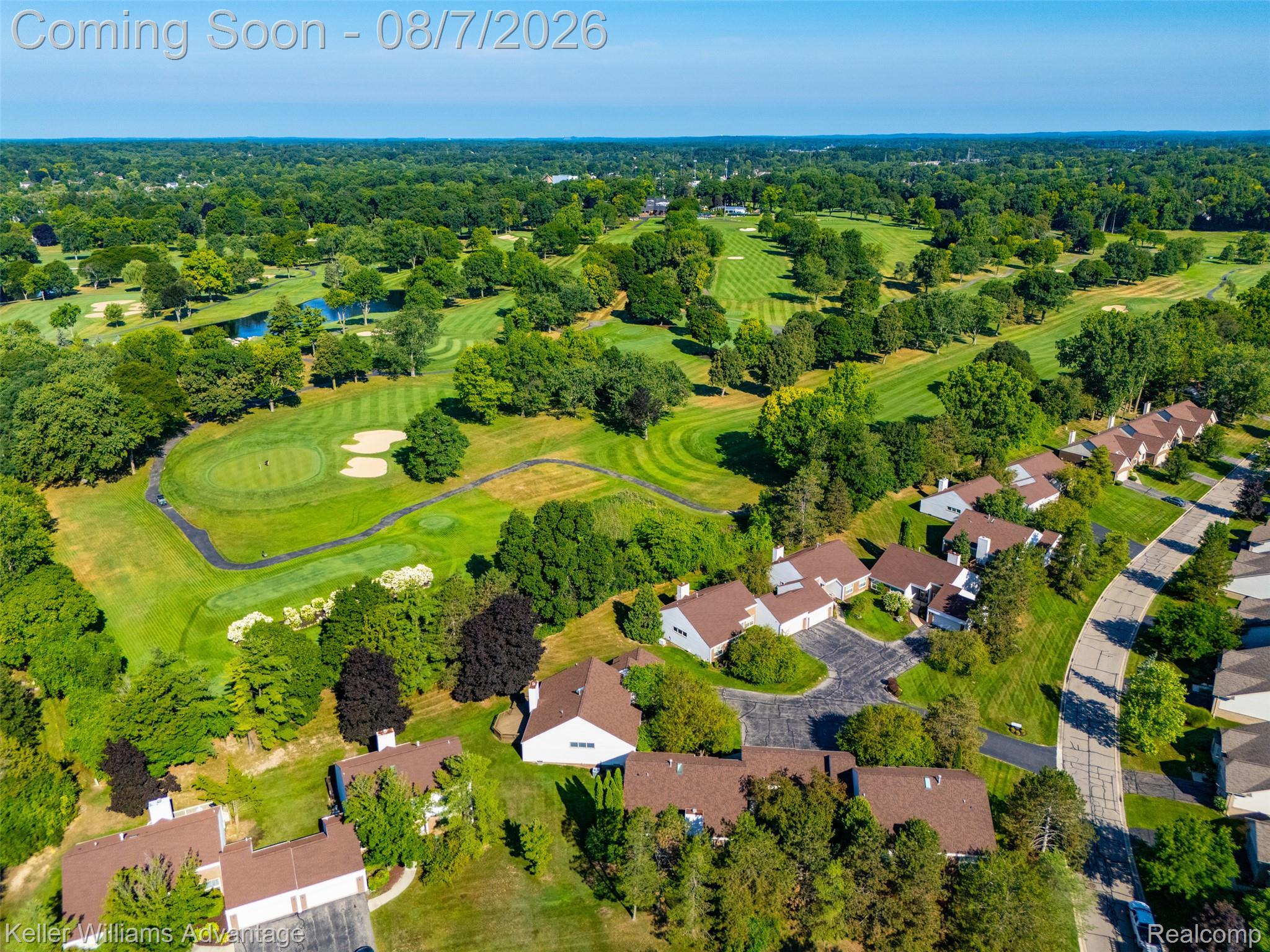5325 Simpson Lake Road West Bloomfield, MI 48323 - Photo 39 of 43 Aerial perspective showcasing the community adjacent to a golf course, featuring multiple residences with brown-shingle roofs, lush green landscaping, and mature trees