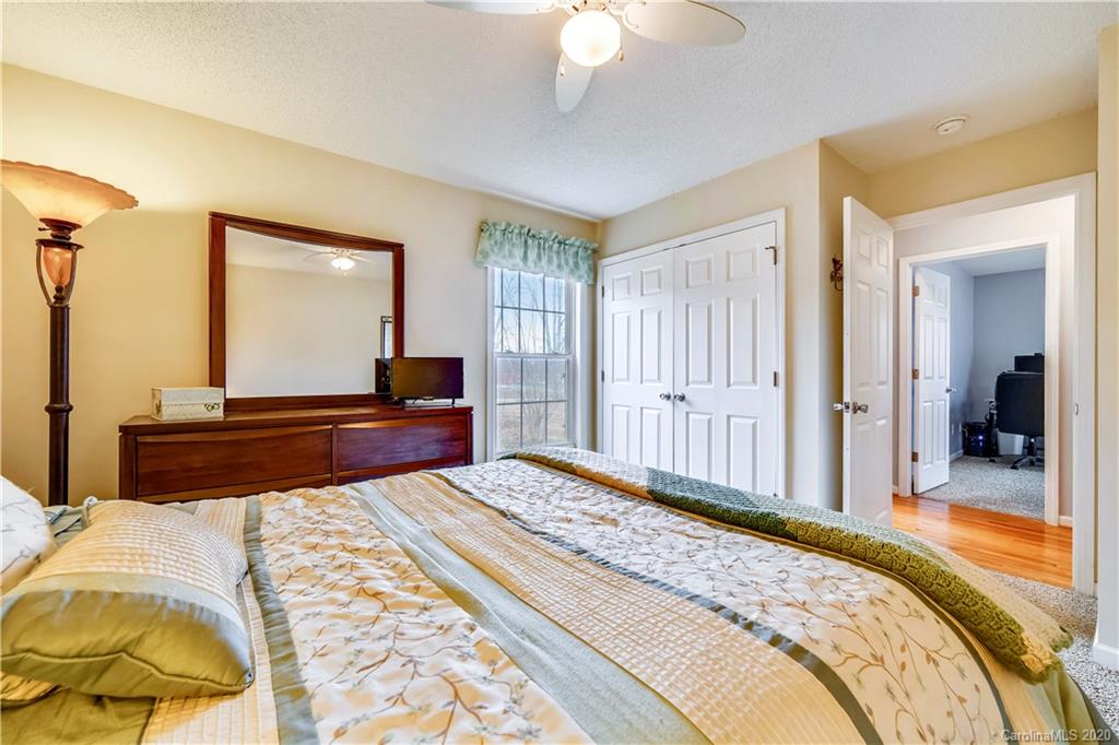 346 Nora Ridge Catawba, SC 29704 - Photo 16 of 29 a bedroom with a large bed and a chandelier