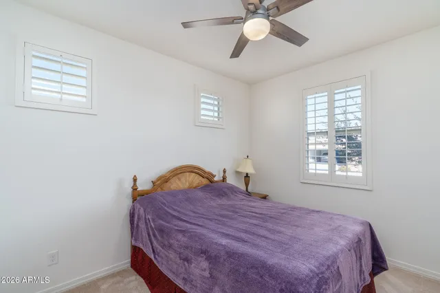 a spacious bathroom with a double vanity sink a mirror and shower