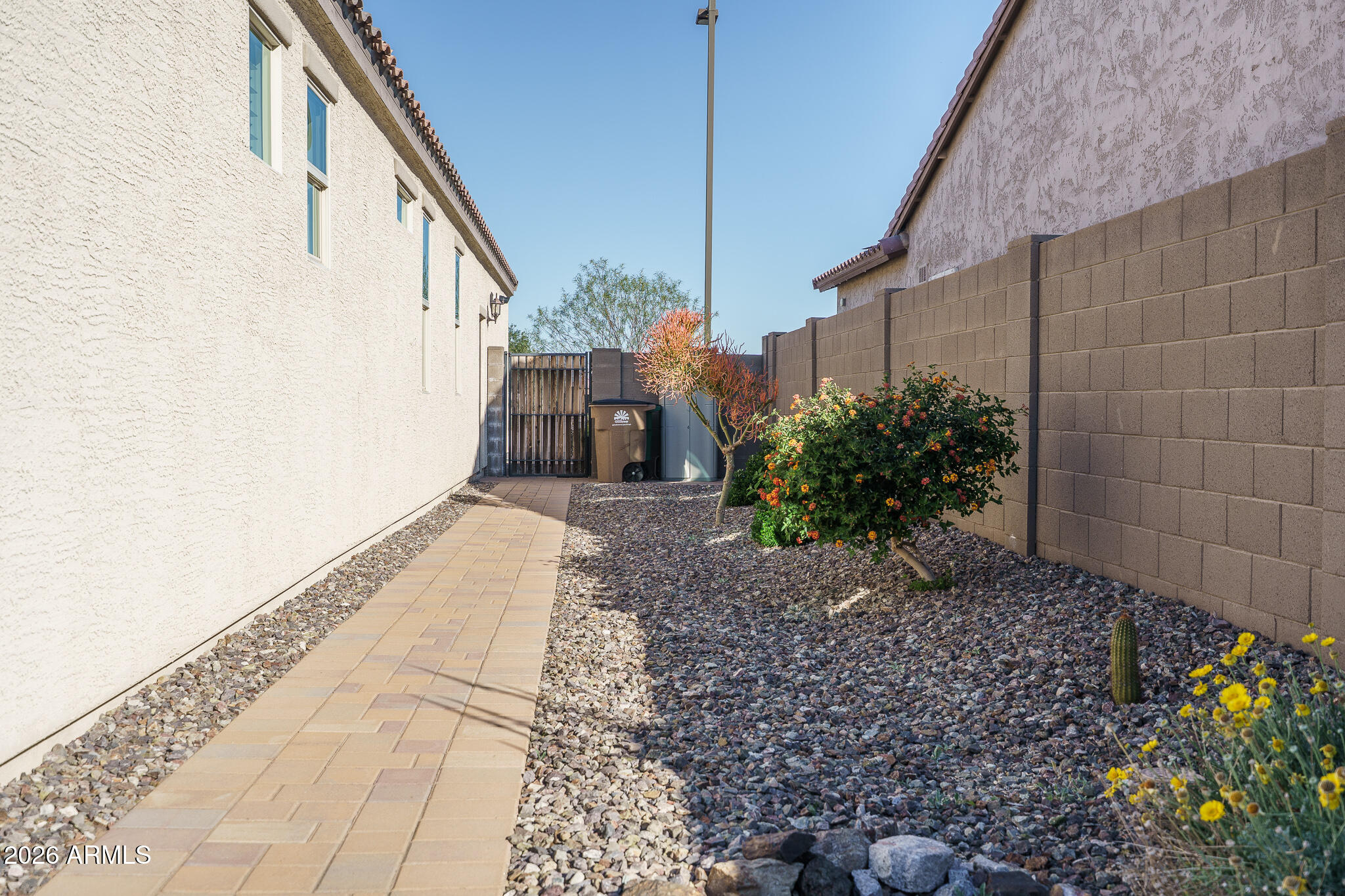 18127 West Fairview Street Goodyear, AZ 85338 - Photo 24 of 48 a view of a pathway of a house with potted plants