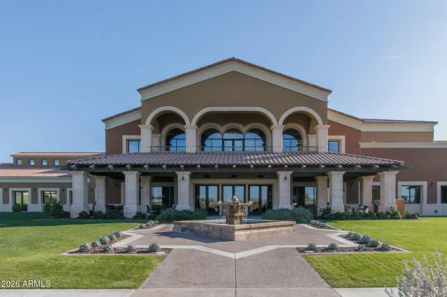 a front view of residential houses with yard and trees