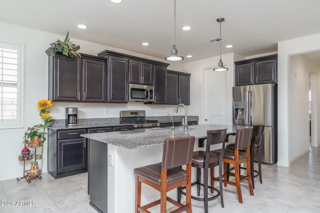 a kitchen with cabinets a sink and appliances