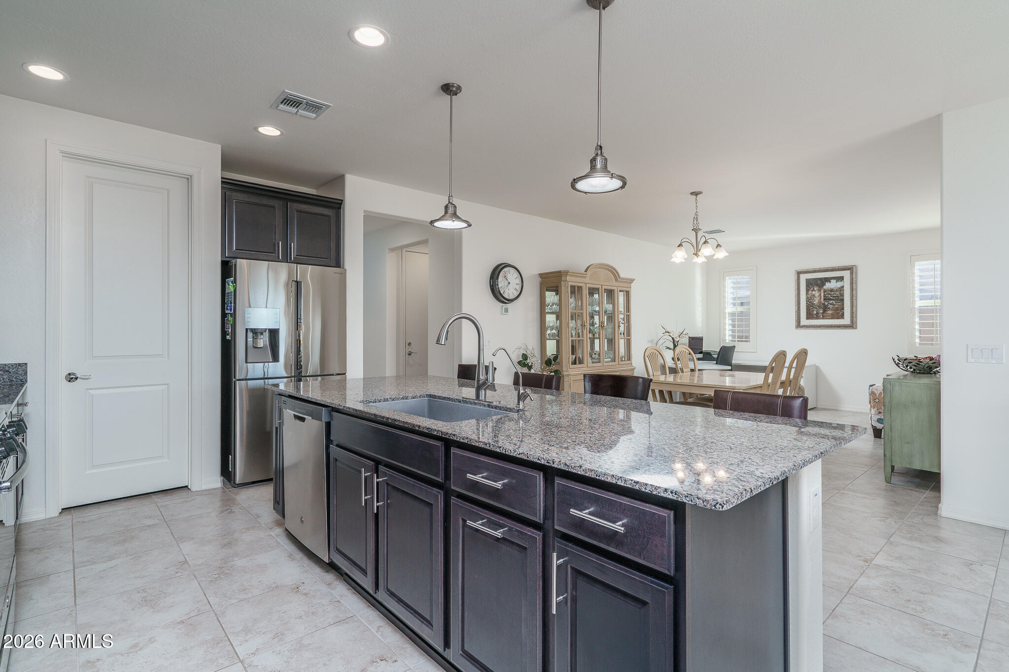 18127 West Fairview Street Goodyear, AZ 85338 - Photo 4 of 48 a large kitchen with a counter space a sink and stainless steel appliances
