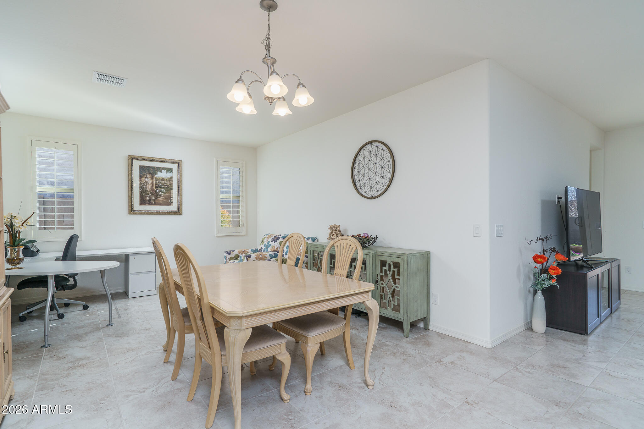 18127 West Fairview Street Goodyear, AZ 85338 - Photo 5 of 48 a dining room with furniture and a chandelier