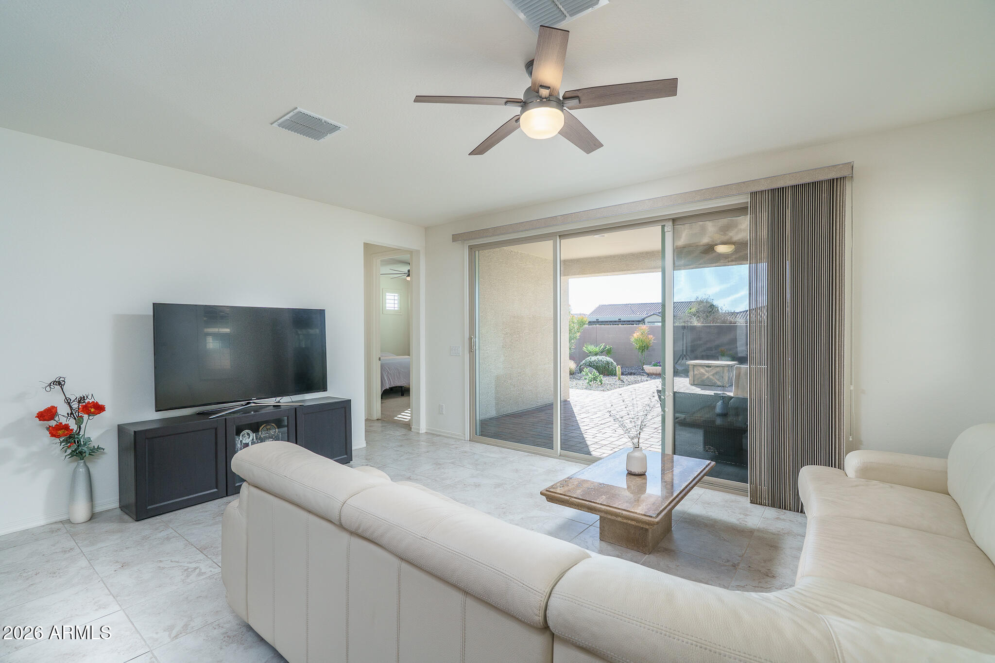 18127 West Fairview Street Goodyear, AZ 85338 - Photo 6 of 48 a living room with furniture and a flat screen tv
