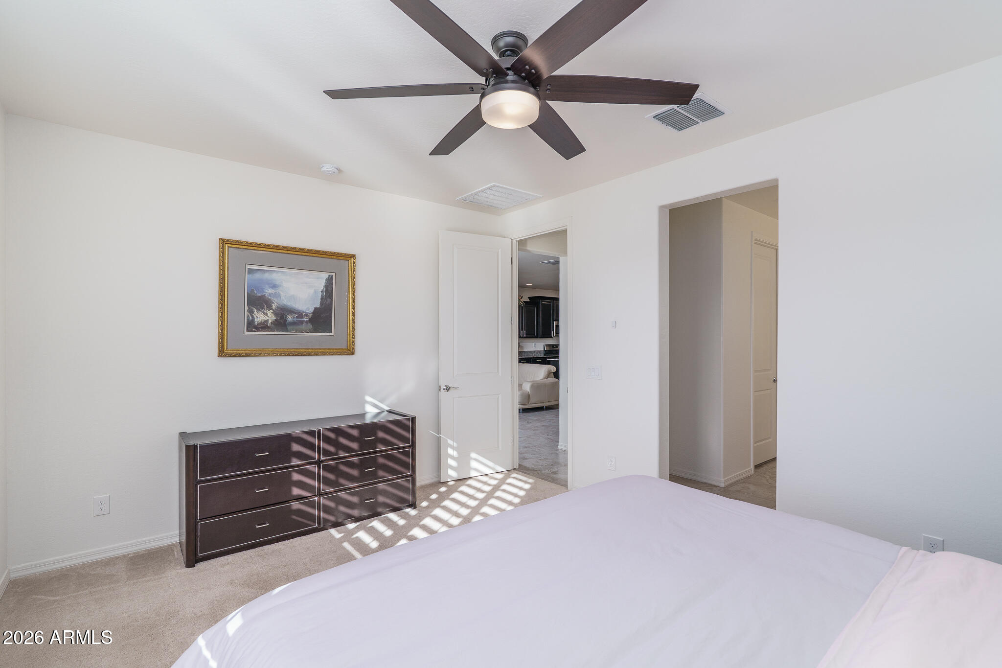 18127 West Fairview Street Goodyear, AZ 85338 - Photo 9 of 48 a bedroom with a bed and a ceiling fan