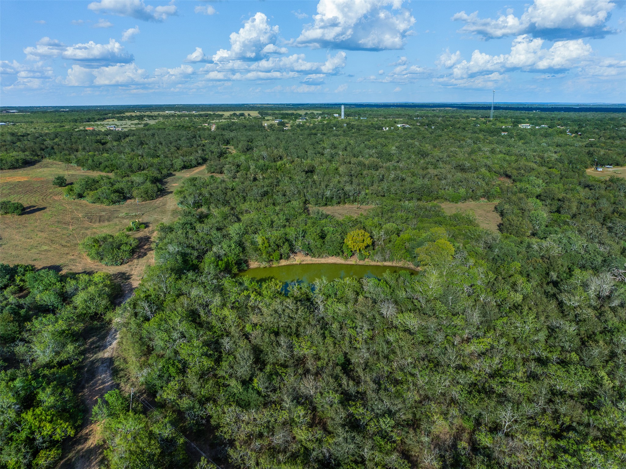 399 Seals Creek Road Lockhart, TX 78644 - Photo 31 of 40 Aerial view of property and surrounding area with a heavily wooded area