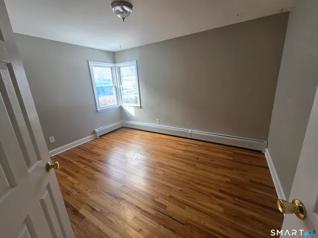 a view of room with window and hardwood floor