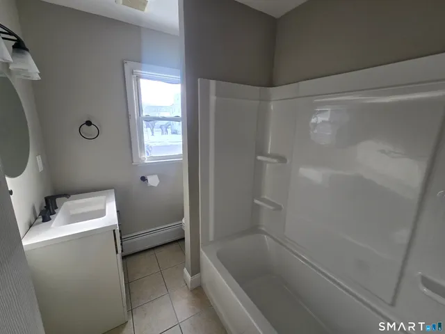 a bathroom with a bathtub and toilet