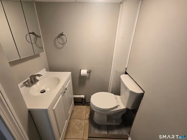 a white toilet sitting next to a bathroom sink