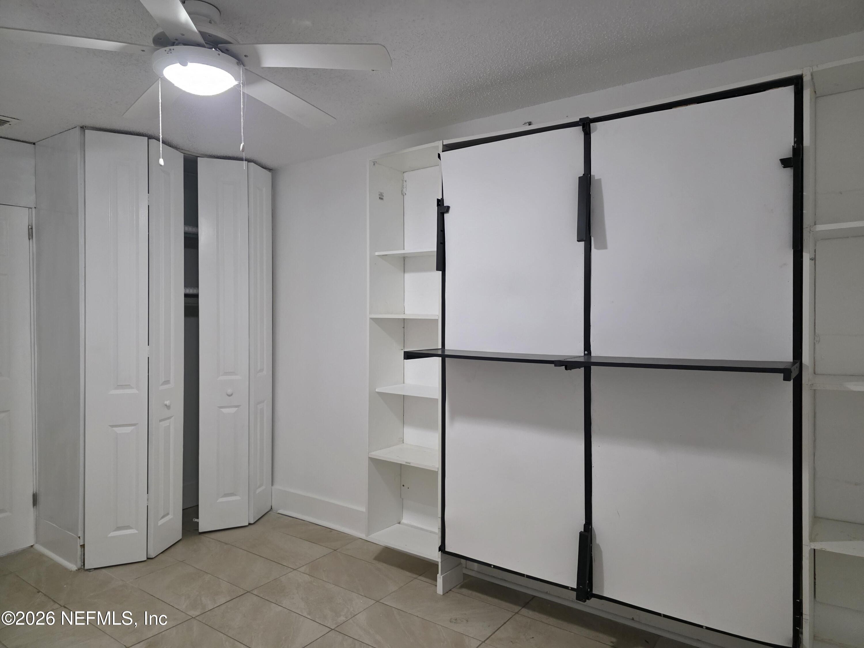 4710 Springfield Boulevard Jacksonville, FL 32206 - Photo 12 of 28 a bathroom with a glass shower door