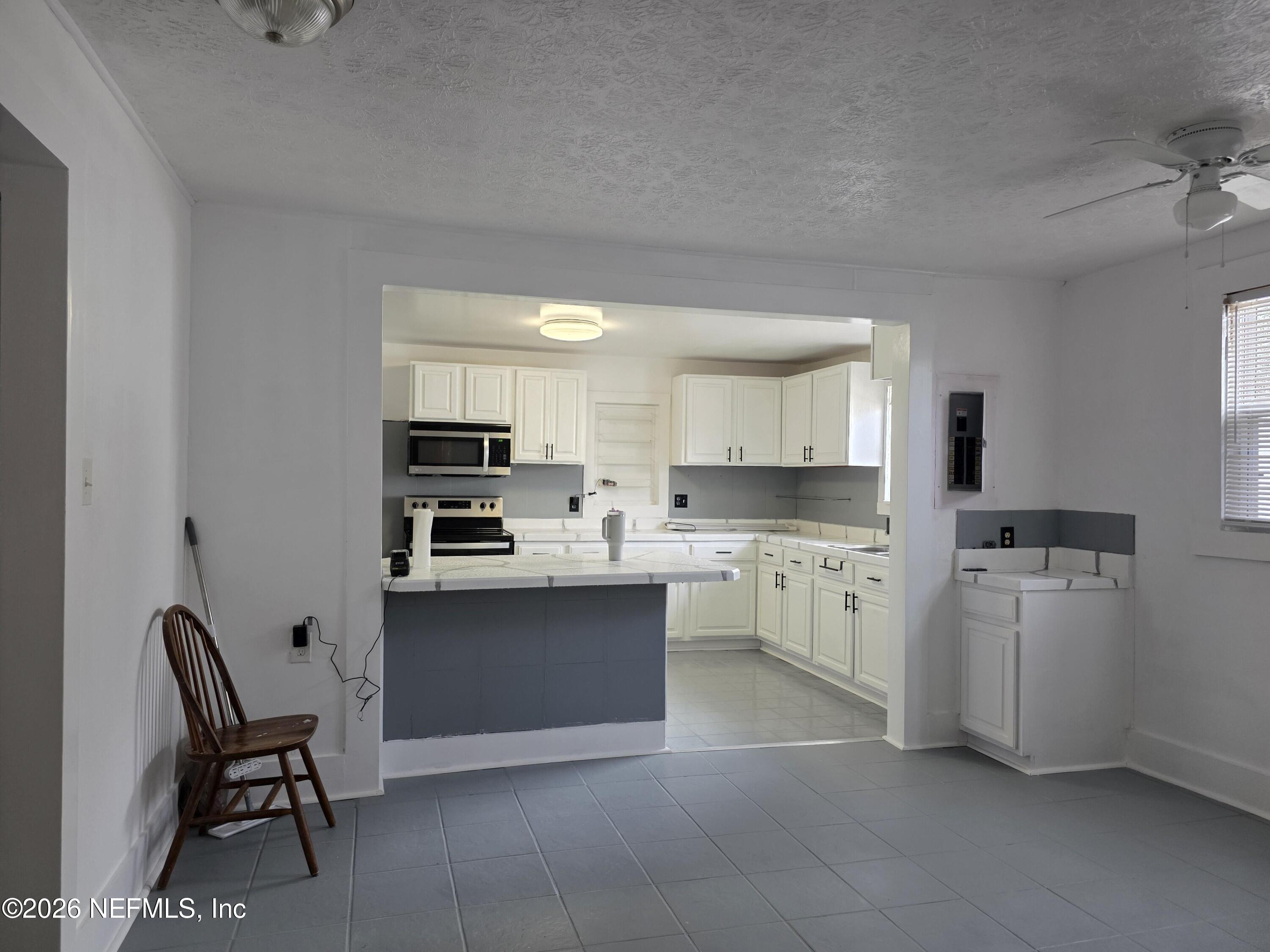 4710 Springfield Boulevard Jacksonville, FL 32206 - Photo 16 of 28 a kitchen with cabinets and wooden floor