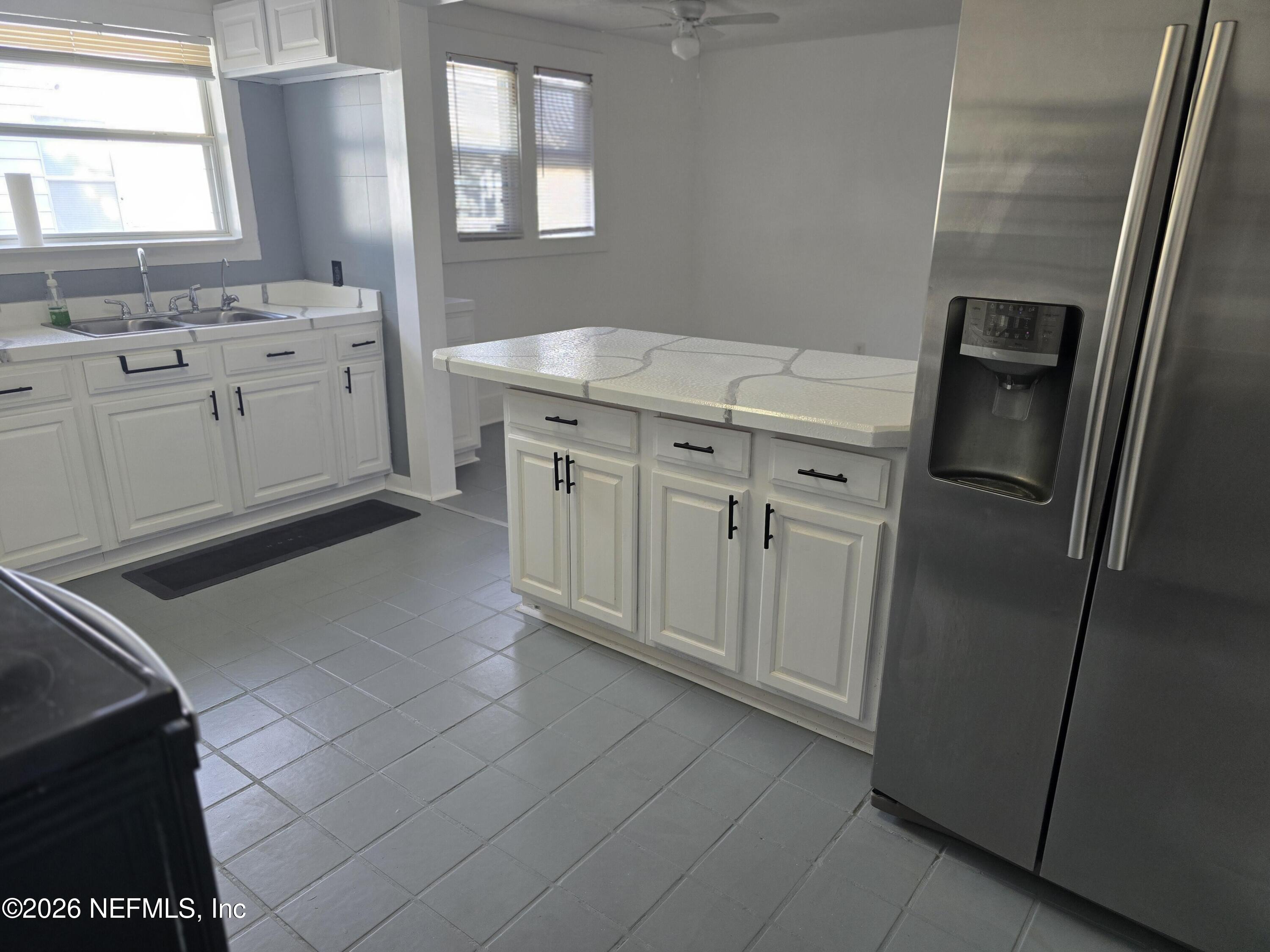 4710 Springfield Boulevard Jacksonville, FL 32206 - Photo 18 of 28 a kitchen with stainless steel appliances a refrigerator sink and cabinets