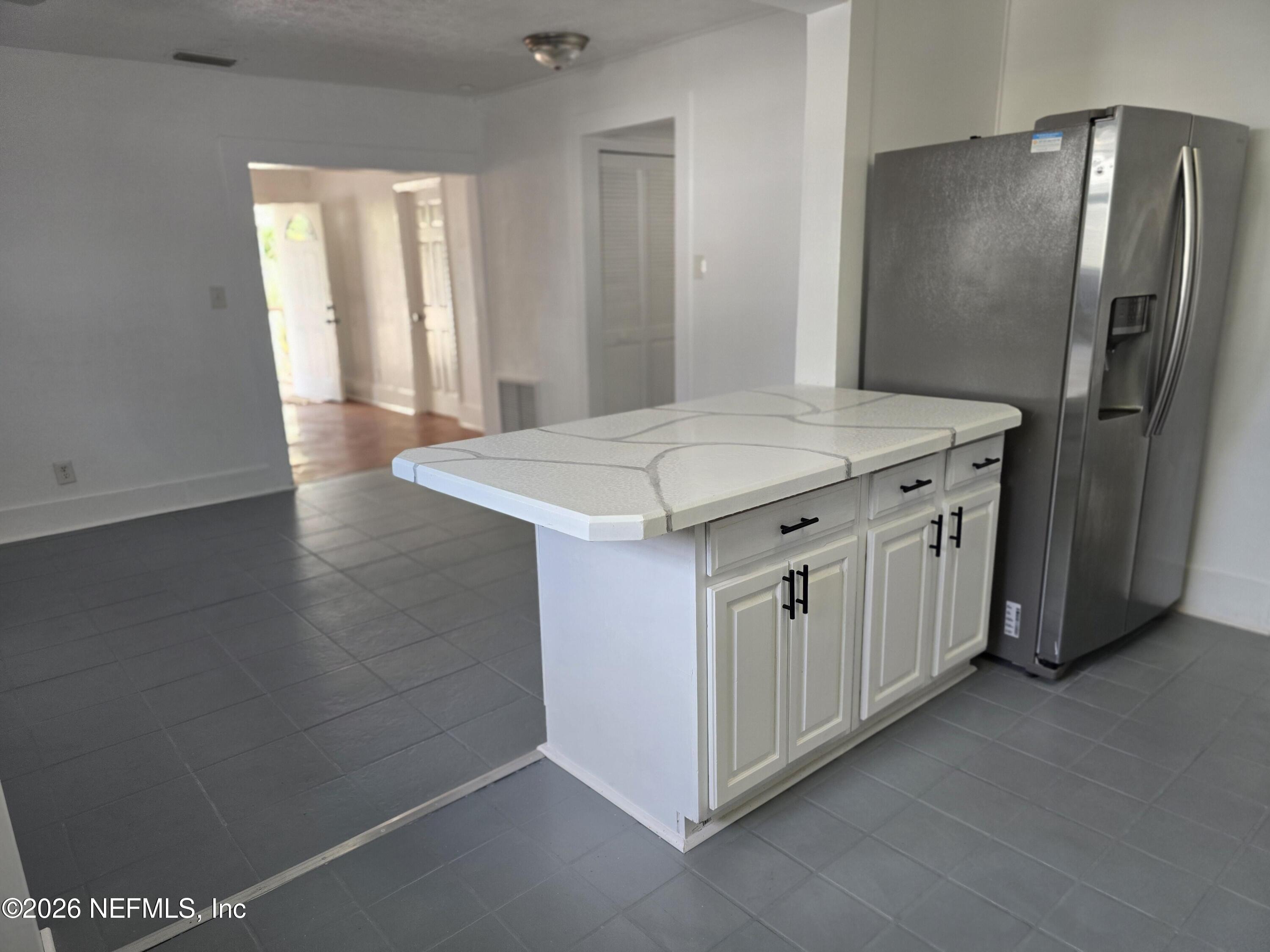 4710 Springfield Boulevard Jacksonville, FL 32206 - Photo 19 of 28 a kitchen with cabinets and wooden floor