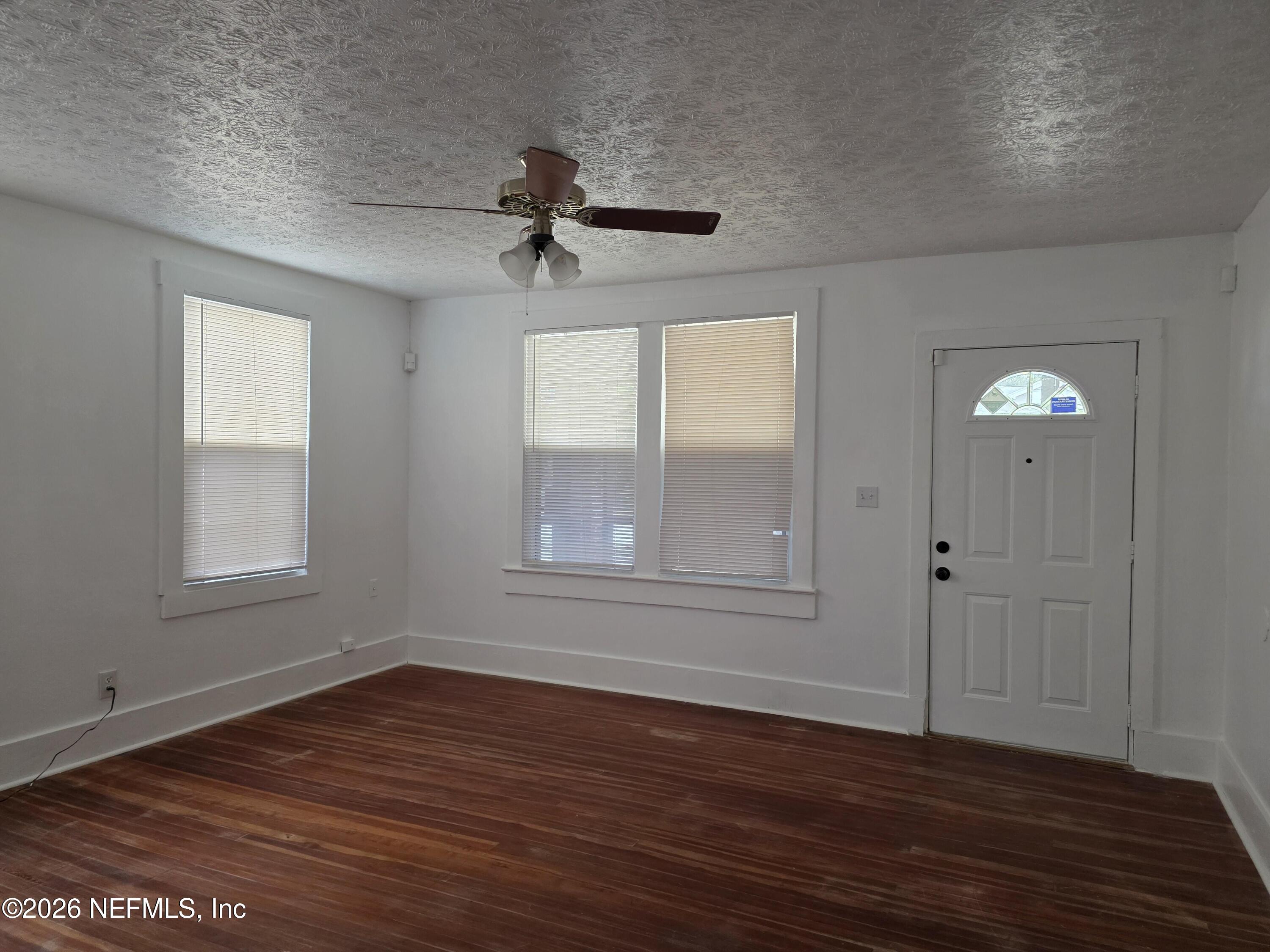 4710 Springfield Boulevard Jacksonville, FL 32206 - Photo 7 of 28 a view of empty room with wooden floor and fan