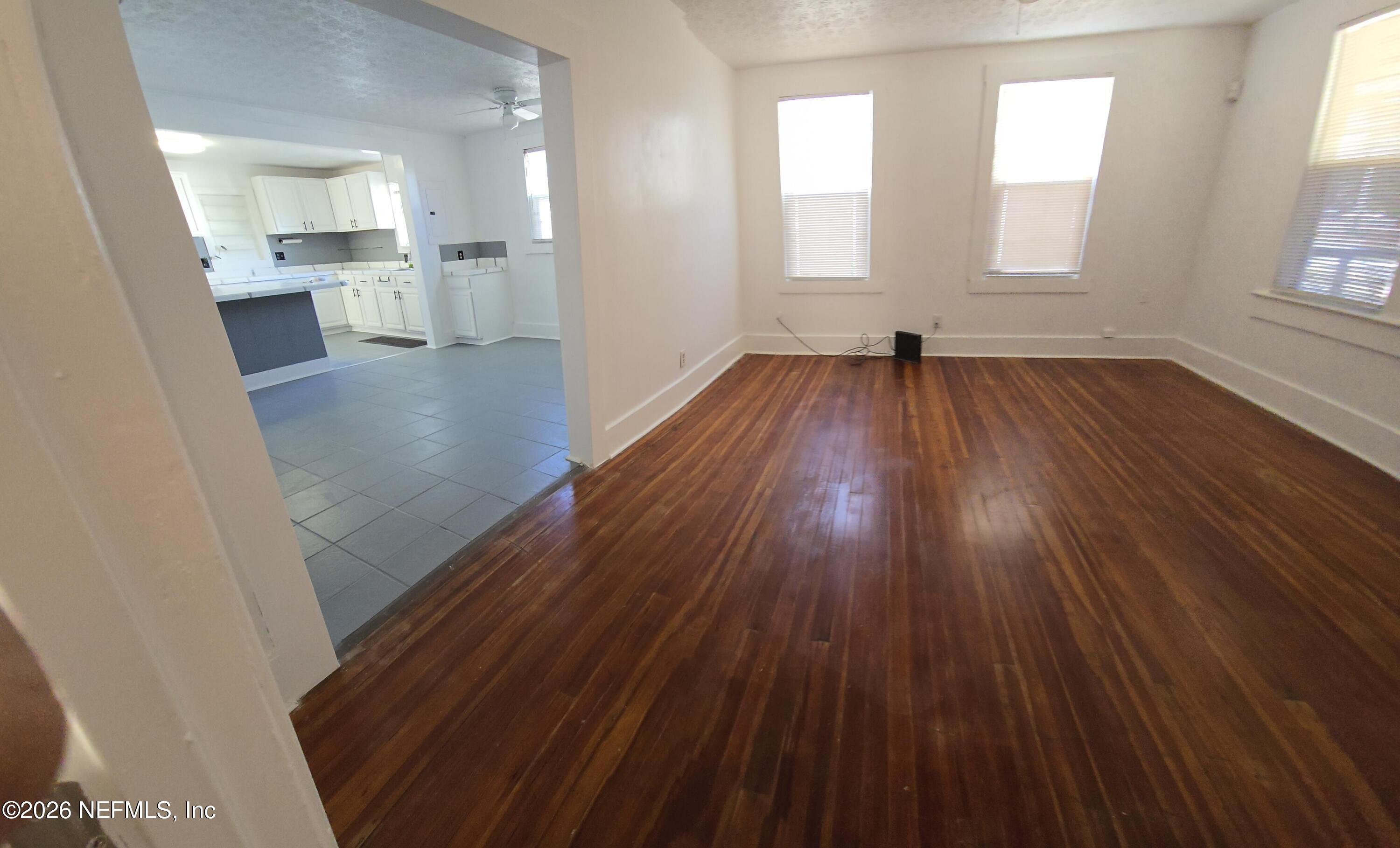 4710 Springfield Boulevard Jacksonville, FL 32206 - Photo 8 of 28 wooden floor in an empty room with a window