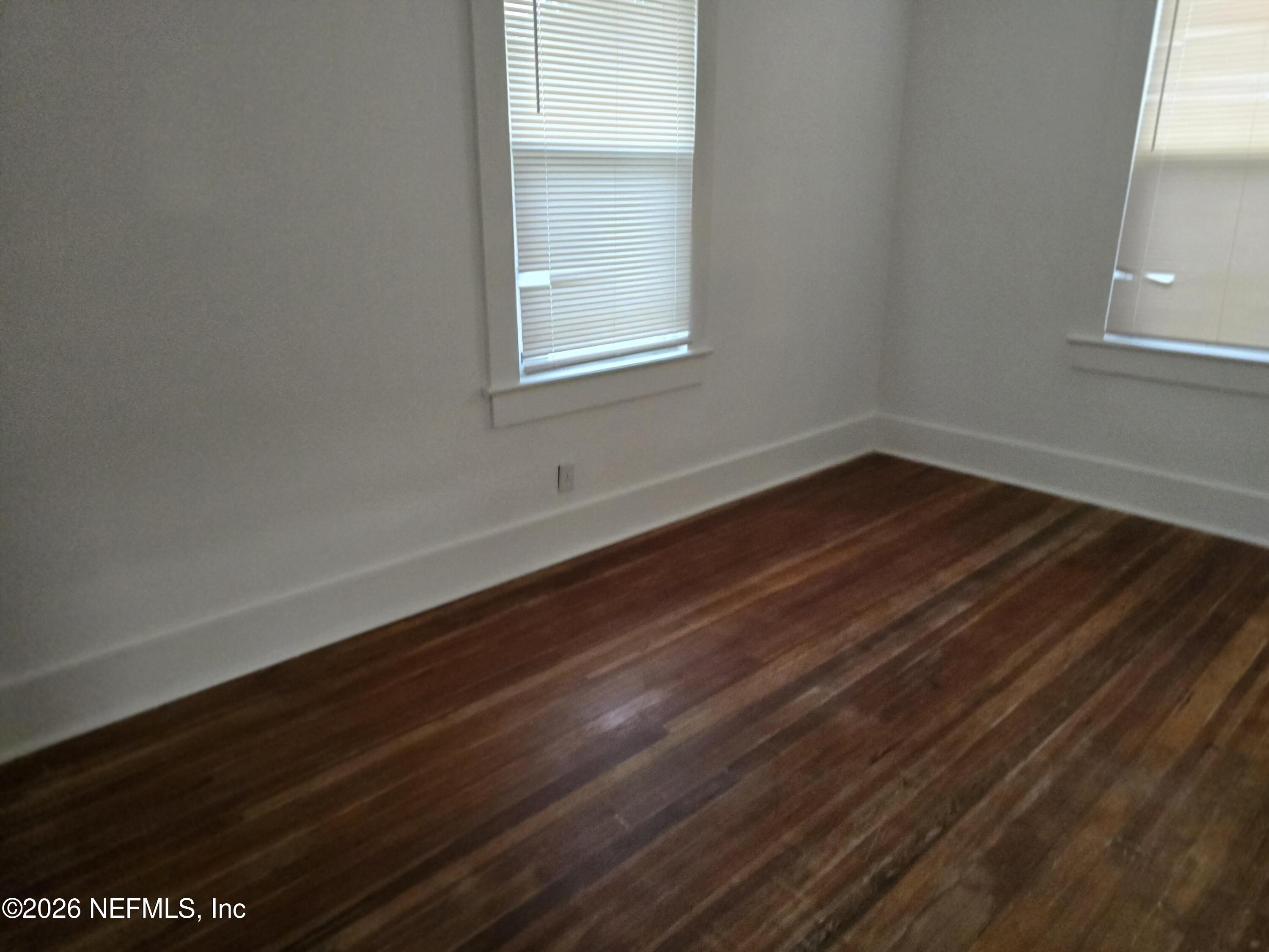 4710 Springfield Boulevard Jacksonville, FL 32206 - Photo 9 of 28 a view of an empty room with wooden floor and a window