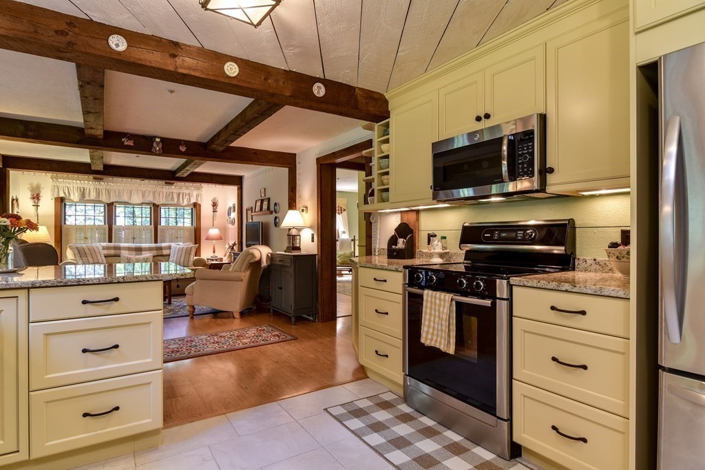 26 Woobly Road Bolton, MA 01740 - Photo 5 of 38 a kitchen with stainless steel appliances kitchen island granite countertop a refrigerator and a stove