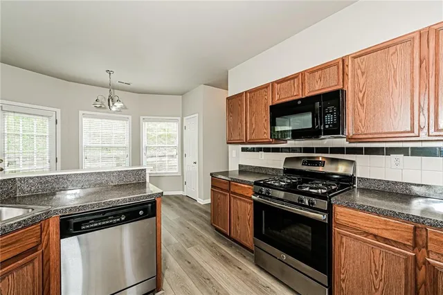 a kitchen with stainless steel appliances a stove and a microwave