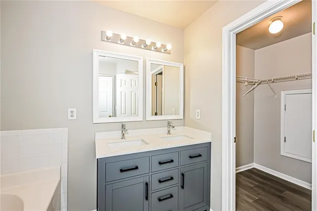 a bathroom with a double vanity sink mirror and