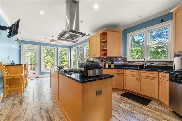 a kitchen with stainless steel appliances granite countertop a sink a stove and a refrigerator