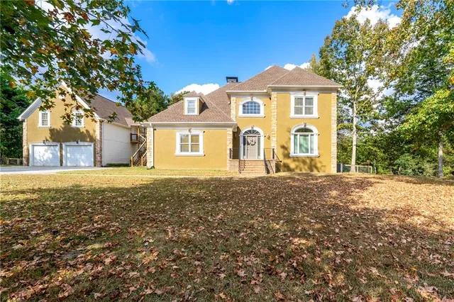 a front view of a house with a yard