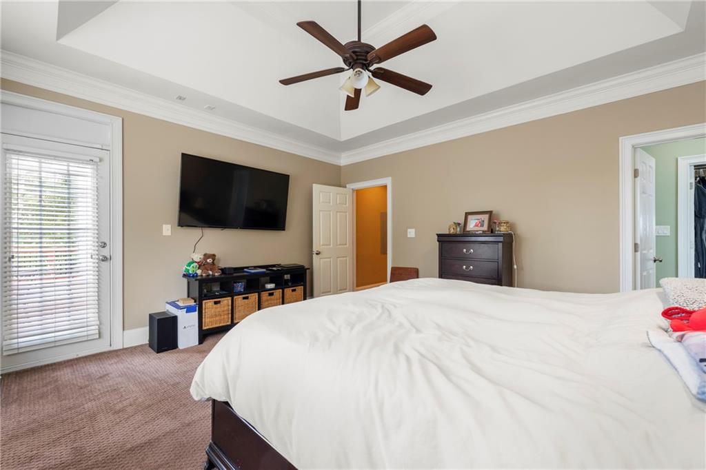 244 Dodgen Road Hampton, GA 30228 - Photo 25 of 55 a bedroom with a bed and a flat screen tv