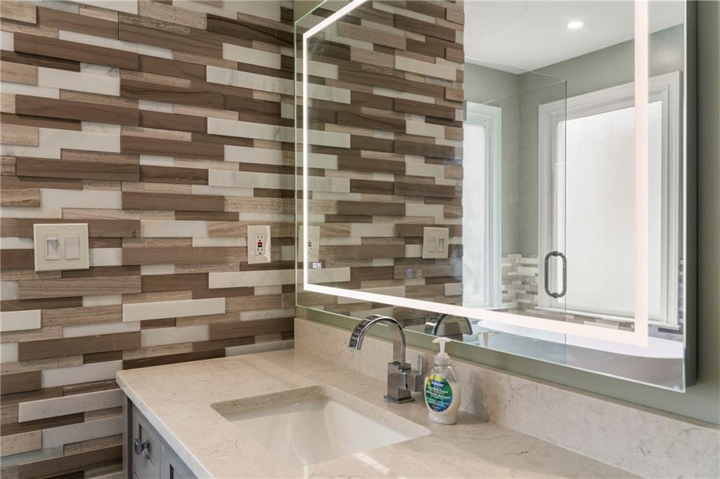 244 Dodgen Road Hampton, GA 30228 - Photo 28 of 55 a kitchen with a sink and a large mirror